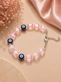 Iridescent light pink crystal and evil eye bead bracelet