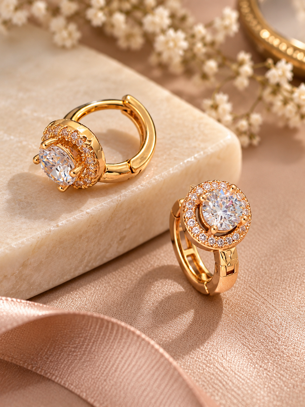 A pair of elegant round halo cubic zirconia huggie hoop earrings