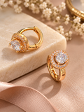 A pair of elegant round halo cubic zirconia huggie hoop earrings