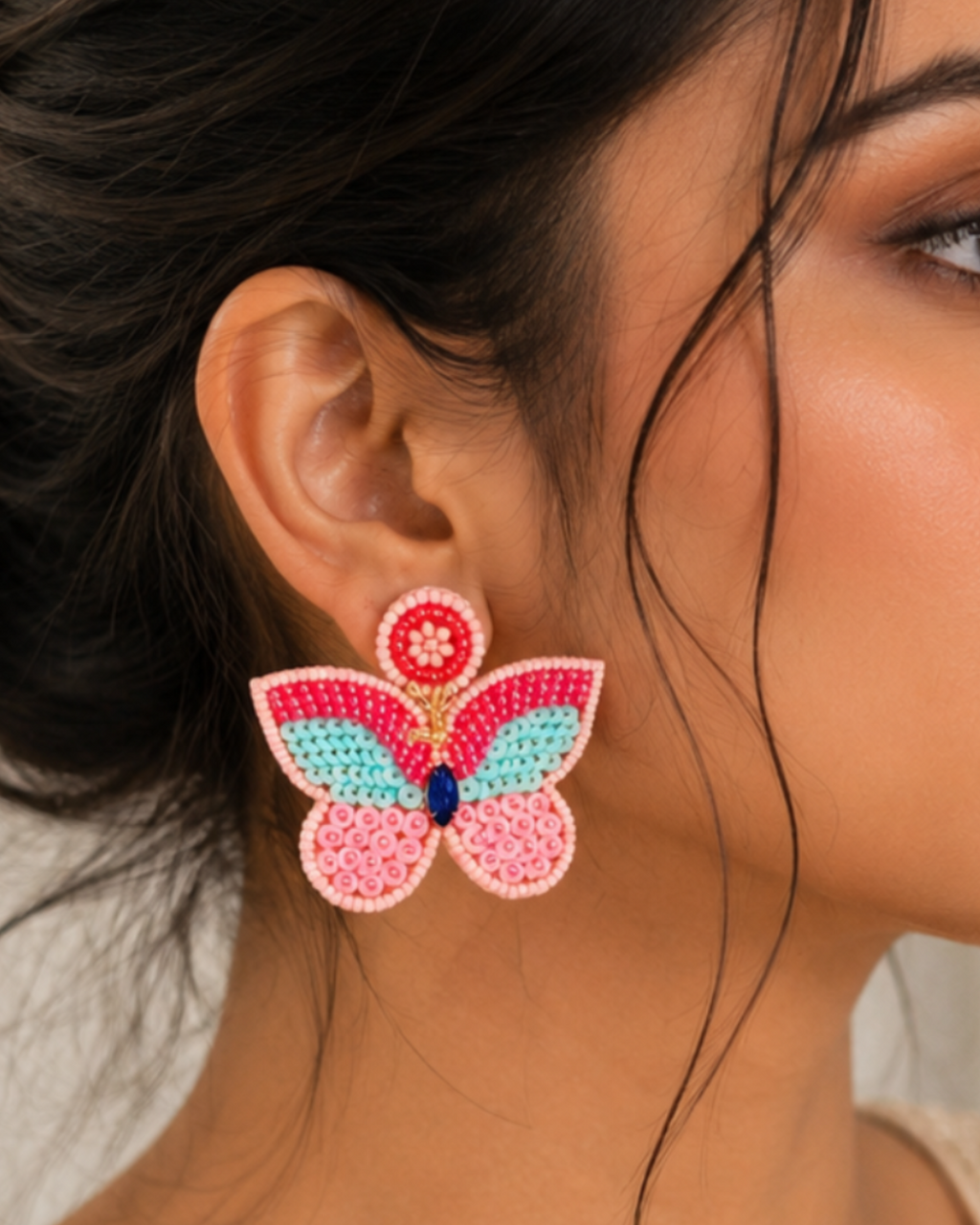 Handmade multi-textured beaded butterfly statement earrings.