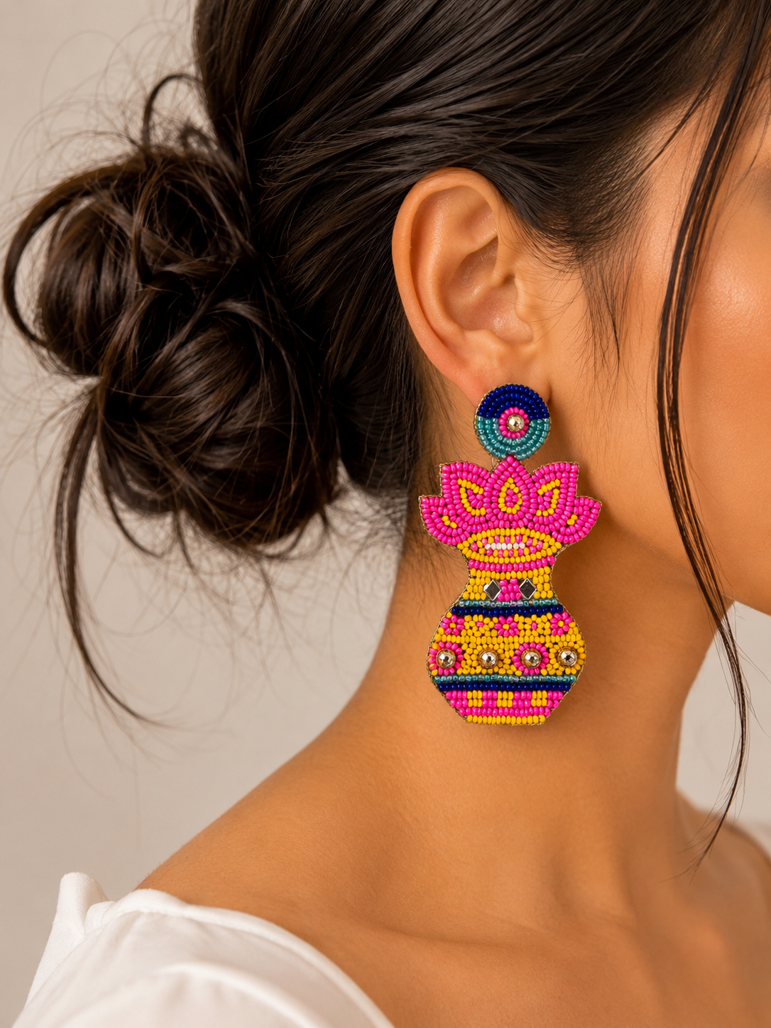 Handmade Kalash and lotus beaded statement earrings.