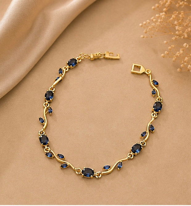 Sapphire blue crystal vine and leaf gold-toned Tulip bracelet