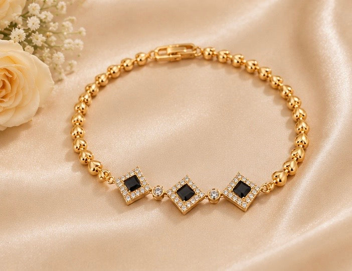 Elegant gold-toned black diamond charm bracelet