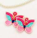 Handmade multi-textured beaded butterfly statement earrings.