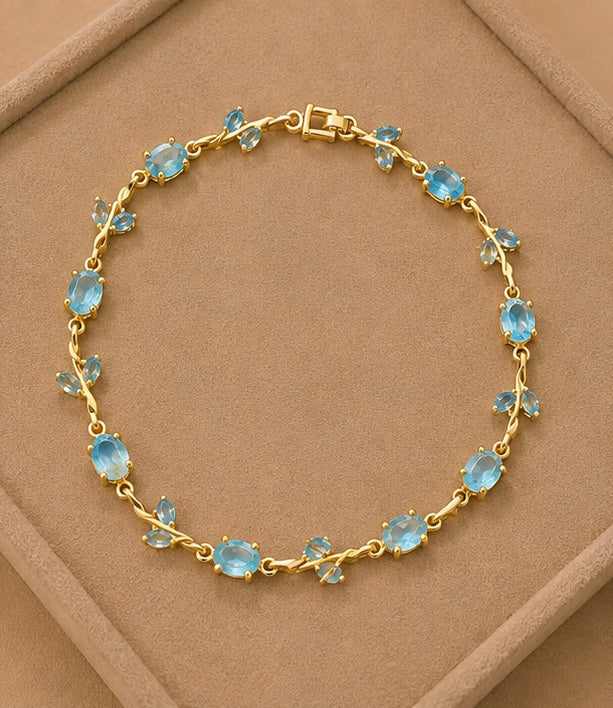 Aquamarine blue crystal vine and leaf gold-toned Tulip bracelet
