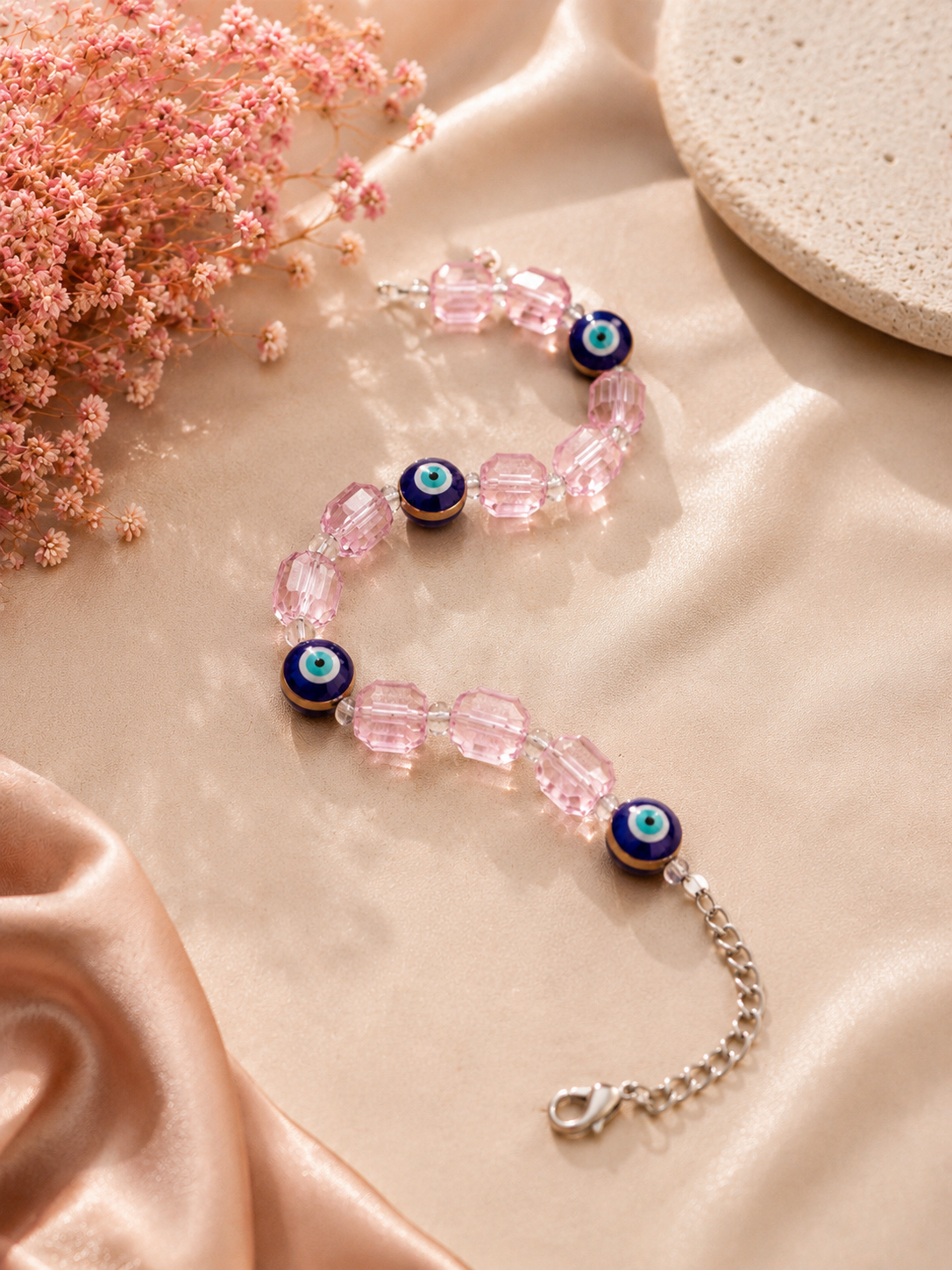 Iridescent light pink crystal and evil eye bead bracelet