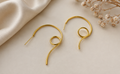 Gold-plated spiral swirl hoop earrings