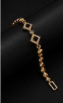 Elegant gold-toned black diamond charm bracelet