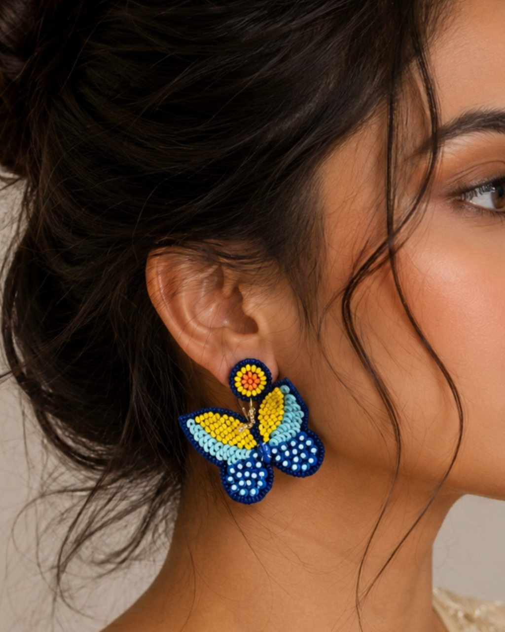 Handmade multi-textured beaded butterfly statement earrings.